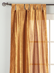 Gold sari tab top curtains hung at a window