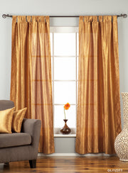 Gold sari tab top curtains hung at a window