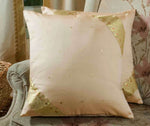 Gold sari cushion covers arranged on a sofa