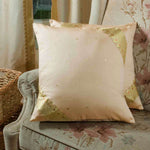 Gold sari cushion covers arranged on a sofa