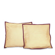 Maroon raw silk cushion covers arranged on a sofa