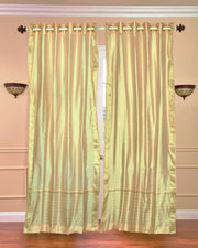 Golden sari grommet top curtains hung at a window
