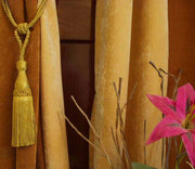 Golden sari curtain tiebacks holding a panel open