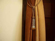 Golden sari curtain tiebacks holding a panel open
