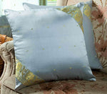 Gray sari cushion covers arranged on a sofa