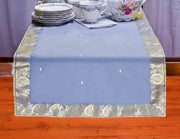 Gray silk table runner running down a dining table