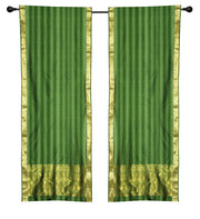 Green sari rod pocket curtains hung at a window