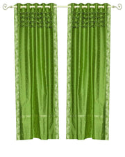 Forest green sari grommet top curtains hung at a window