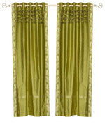Olive green sari grommet top curtains hung at a window