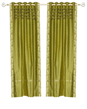 Olive green sari grommet top curtains hung at a window