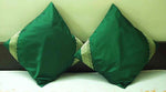 Forest green sari cushion covers arranged on a sofa