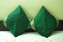 Forest green sari cushion covers arranged on a sofa