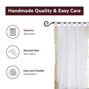 White sari tab top curtains hung at a window