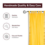 Yellow sari tab top curtains hung at a window