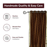 Brown sari grommet top curtains hung at a window
