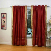 Rust sari rod pocket curtains hung at a window