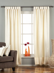 Cream sari tab top curtains hung at a window