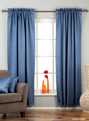 Blue sari rod pocket curtains hung at a window
