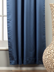 Blue sari rod pocket curtains hung at a window