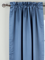 Blue sari rod pocket curtains hung at a window