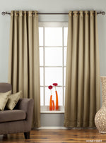 Olive green sari grommet top curtains hung at a window