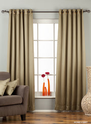 Olive green sari grommet top curtains hung at a window