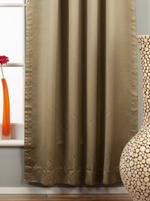 Olive green sari tab top curtains hung at a window