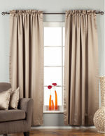 Gray sari rod pocket curtains hung at a window