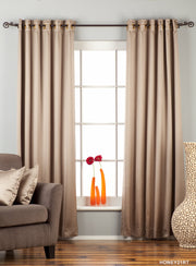 Gray sari grommet top curtains hung at a window