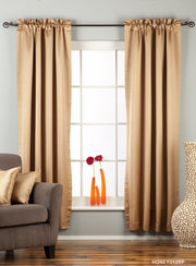 Taupe sari rod pocket curtains hung at a window