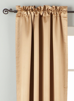 Taupe sari rod pocket curtains hung at a window