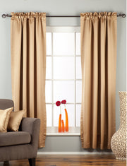 Taupe sari rod pocket curtains hung at a window