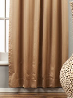 Taupe sari grommet top curtains hung at a window