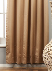 Taupe sari grommet top curtains hung at a window