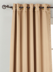 Taupe sari grommet top curtains hung at a window