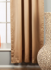 Taupe sari tab top curtains hung at a window