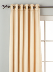 Golden sari grommet top curtains hung at a window