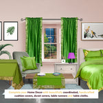 Forest green sari rod pocket curtains hung at a window