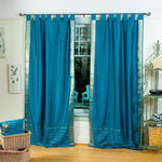 Turquoise sari tab top curtains hung at a window