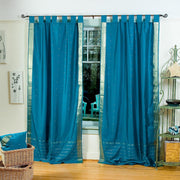 Turquoise sari tab top curtains hung at a window