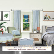 Gray sari tab top curtains hung at a window