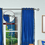 Blue sari grommet top curtains hung at a window