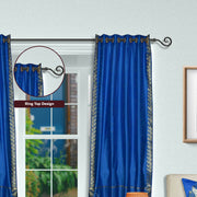 Blue sari grommet top curtains hung at a window
