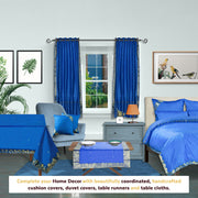 Blue sari grommet top curtains hung at a window