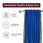 Blue sari grommet top curtains hung at a window