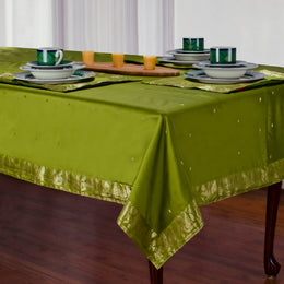 Olive green sari tablecloth laid on a dining table