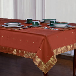 Rust sari tablecloth laid on a dining table