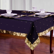 Black sari tablecloth laid on a dining table