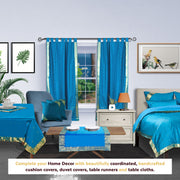 Turquoise sari tab top curtains hung at a window