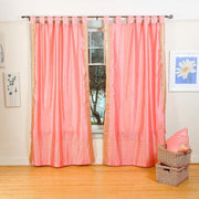 Pink sari tab top curtains hung at a window